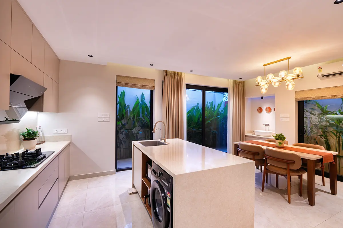 Open-plan kitchen island with dining area and lush garden view