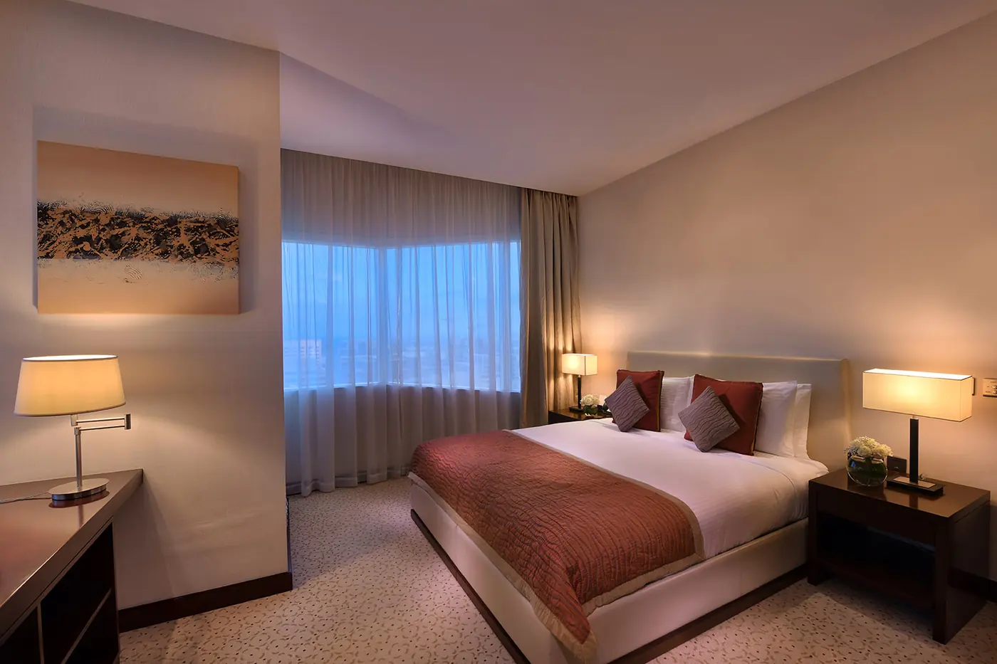 Hotel bedroom interior with warm ambient lighting and city view