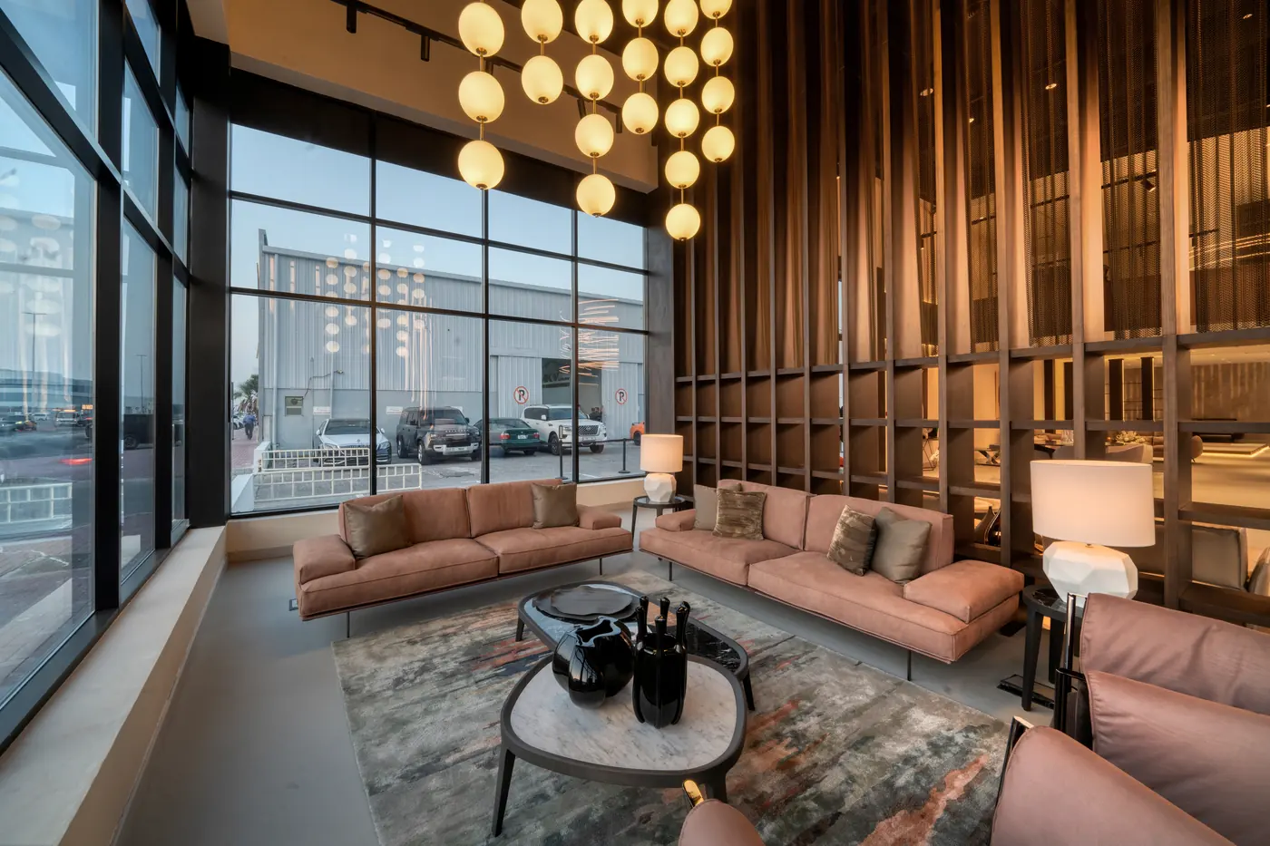 Showroom lounge interior with double-height ceiling and pendant lighting