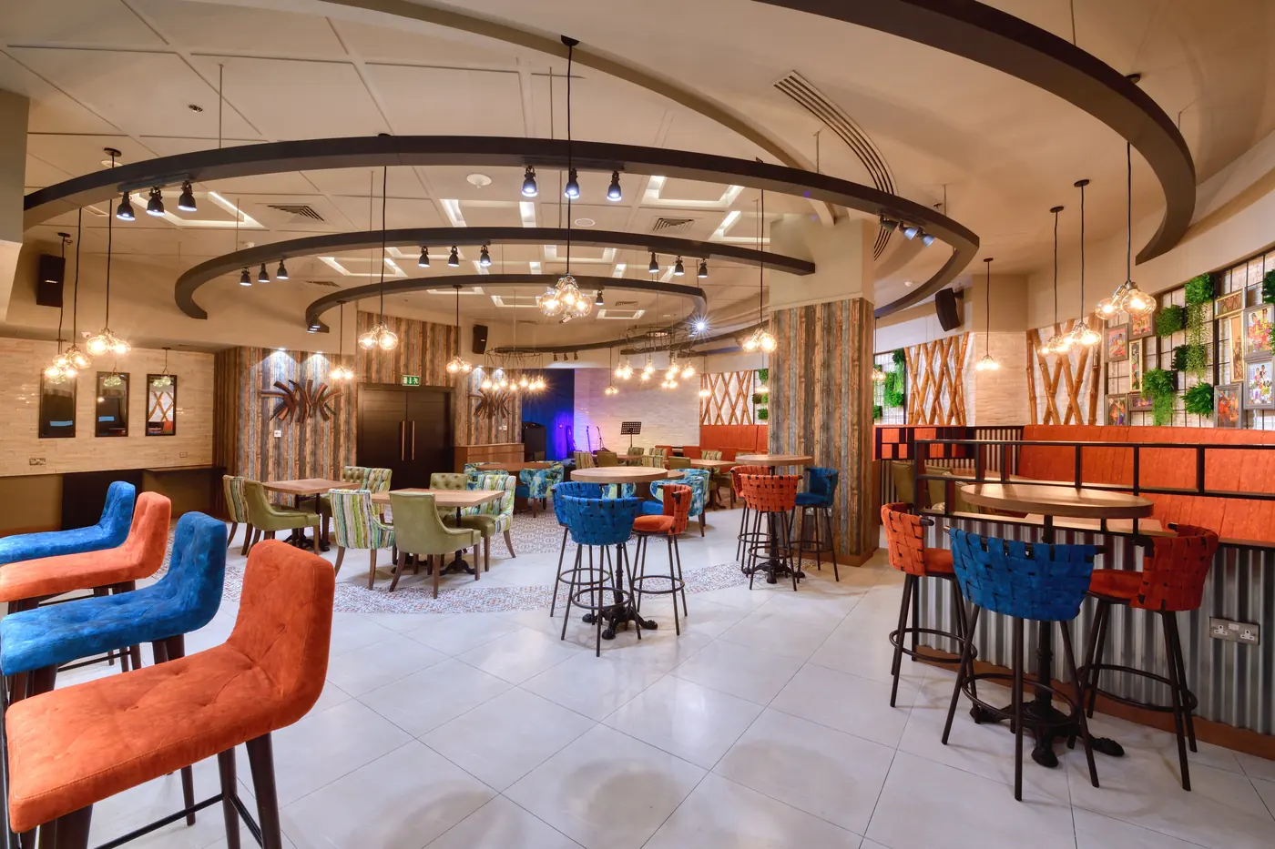 Restaurant and bar interior photography with colourful seating and pendant lighting