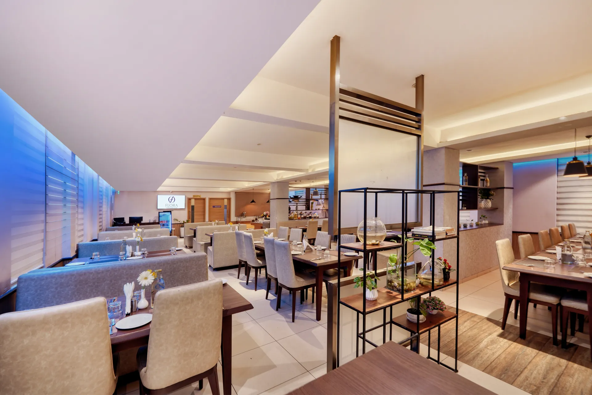 Hotel restaurant with metal display shelving, banquette seating and ambient lighting — hotel properties shot in Kochi, Kerala, Bengaluru (Bangalore)