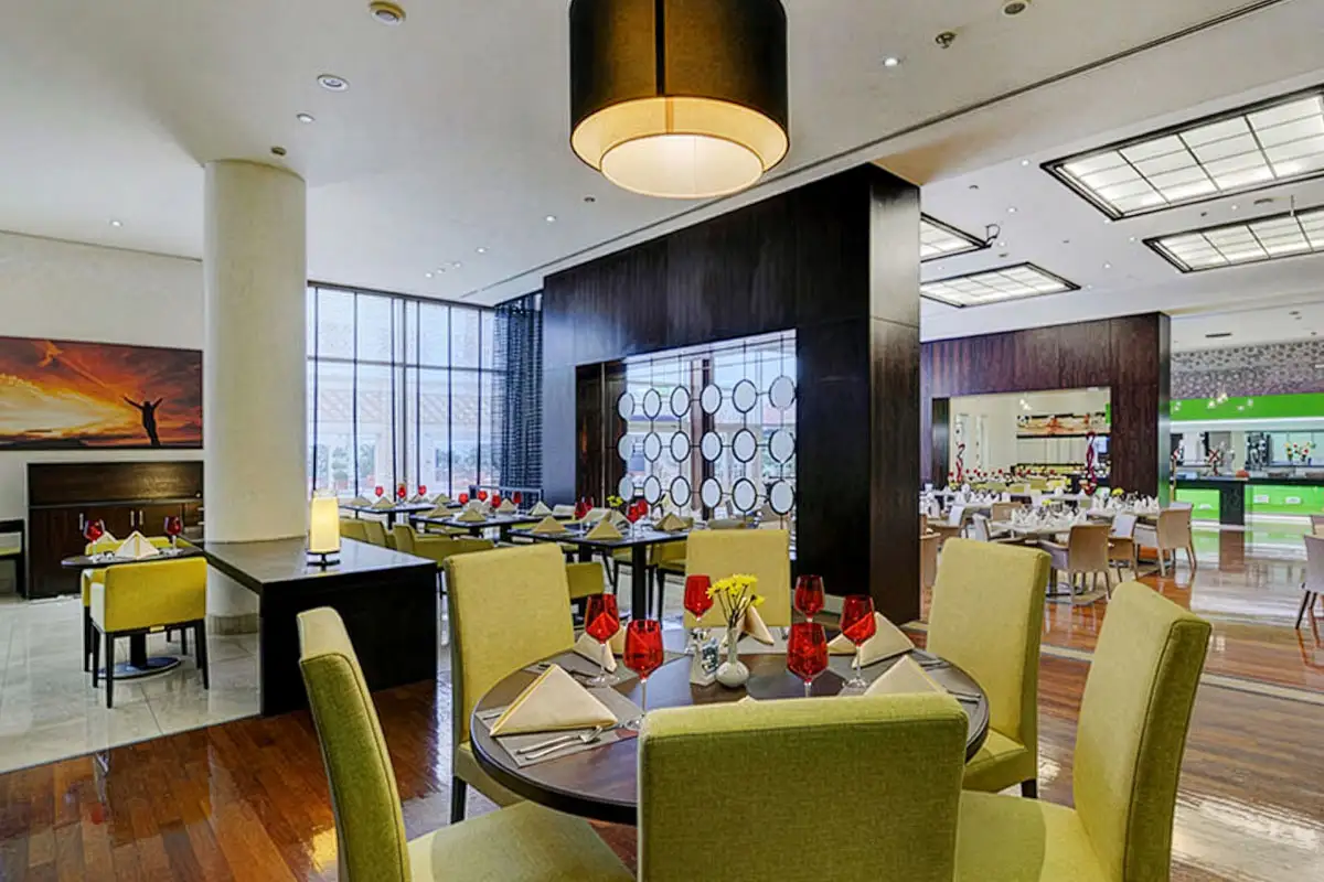 Hotel restaurant seating area with round table and pendant lighting
