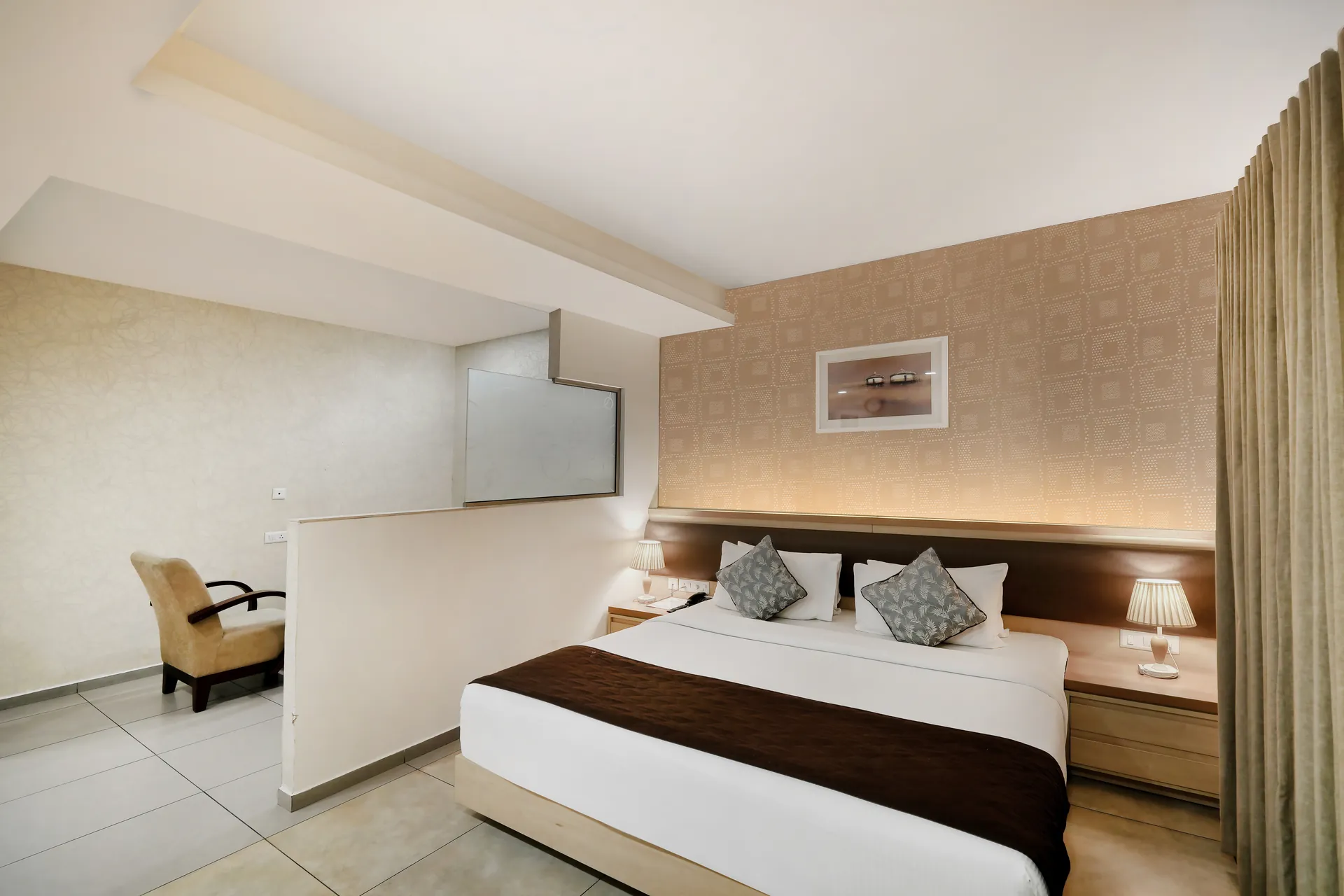 Hotel/Resort king bedroom with sitting nook, frosted glass partition and warm cove lighting — hotel properties shot in Mumbai, Kochi, Kerala, Bengaluru (Bangalore)